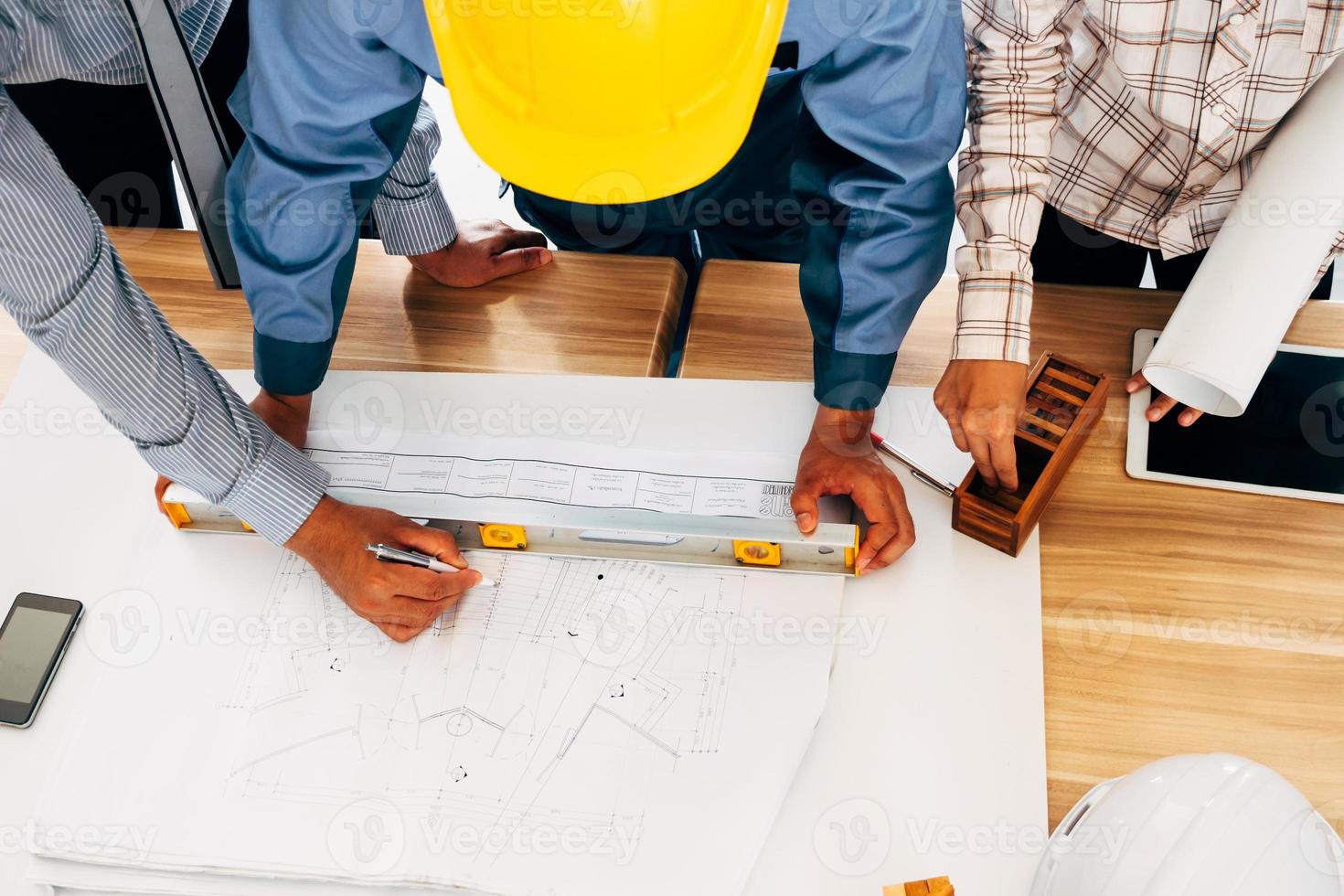Team of engineers discussing architecture plan sketch at the construction site. photo