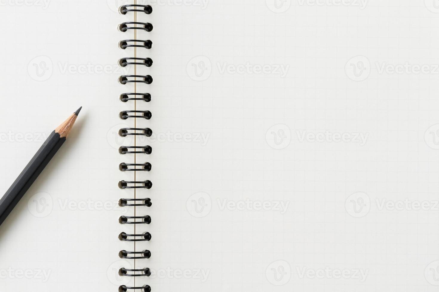 Close up of blank spiral notebook and pencil. photo