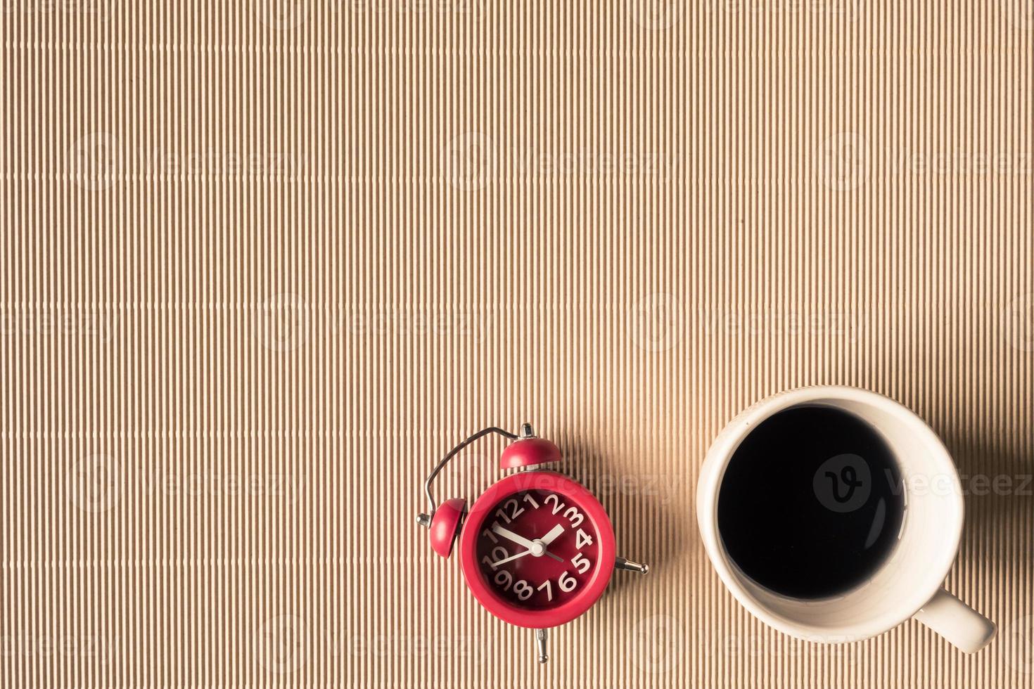 Top view of coffee cup with clock on table. Free space for text photo