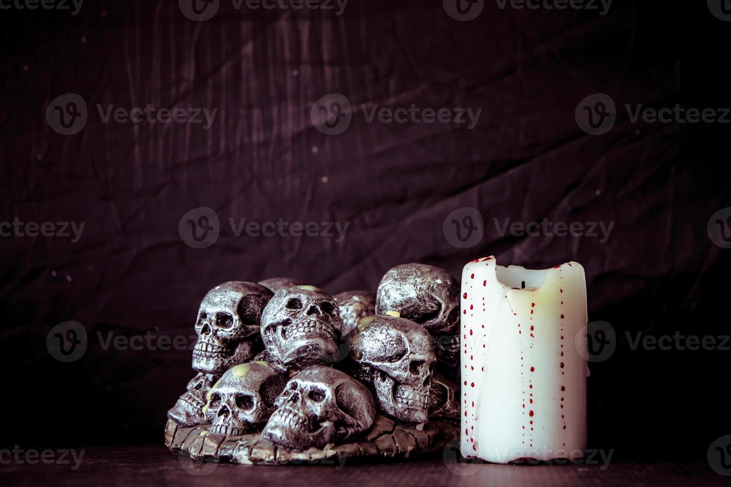 Skulls and candle  on a black background. Vintage tone. photo