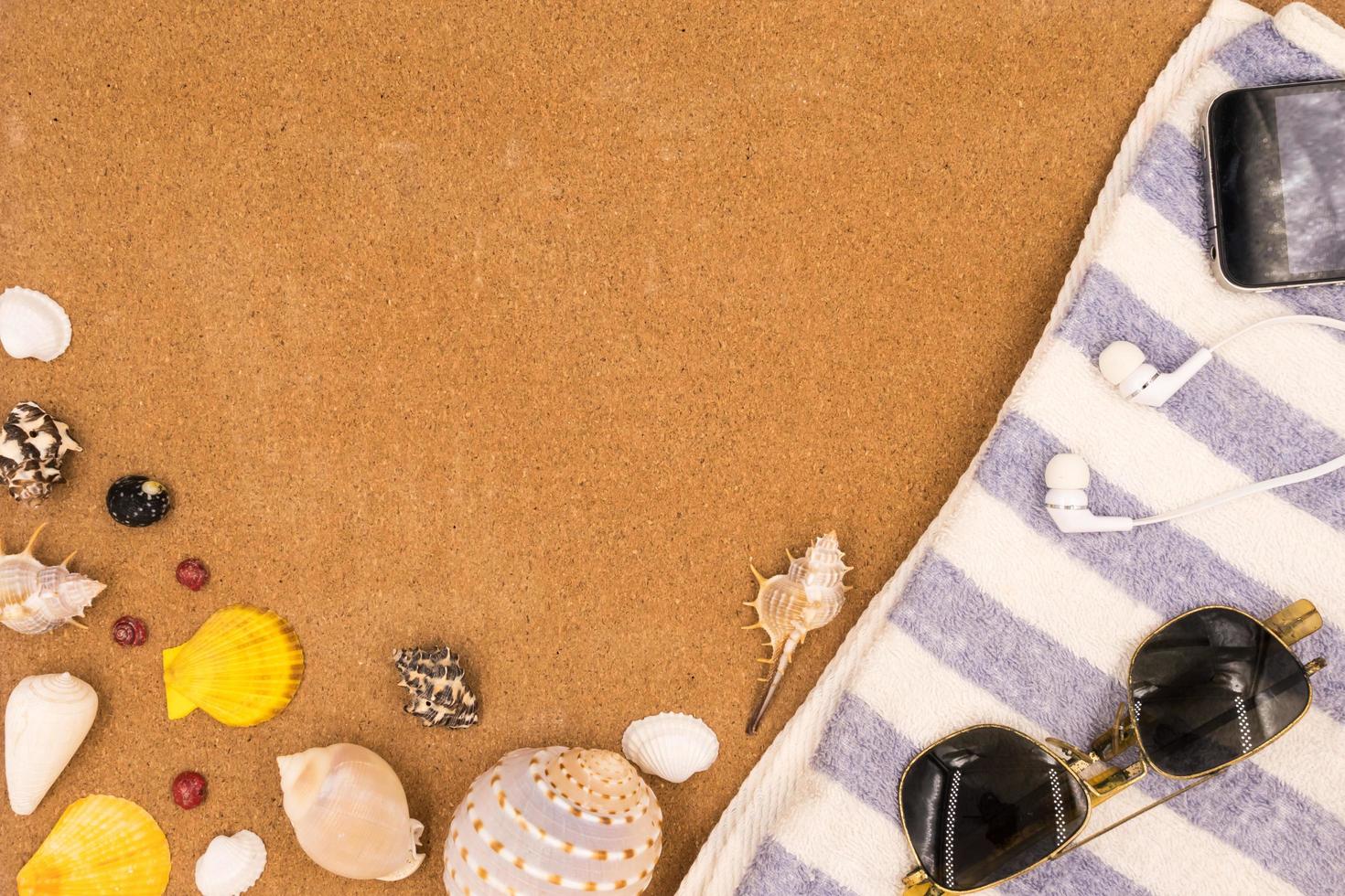 Top view of Travel accessories and Seashells on brown board background. photo