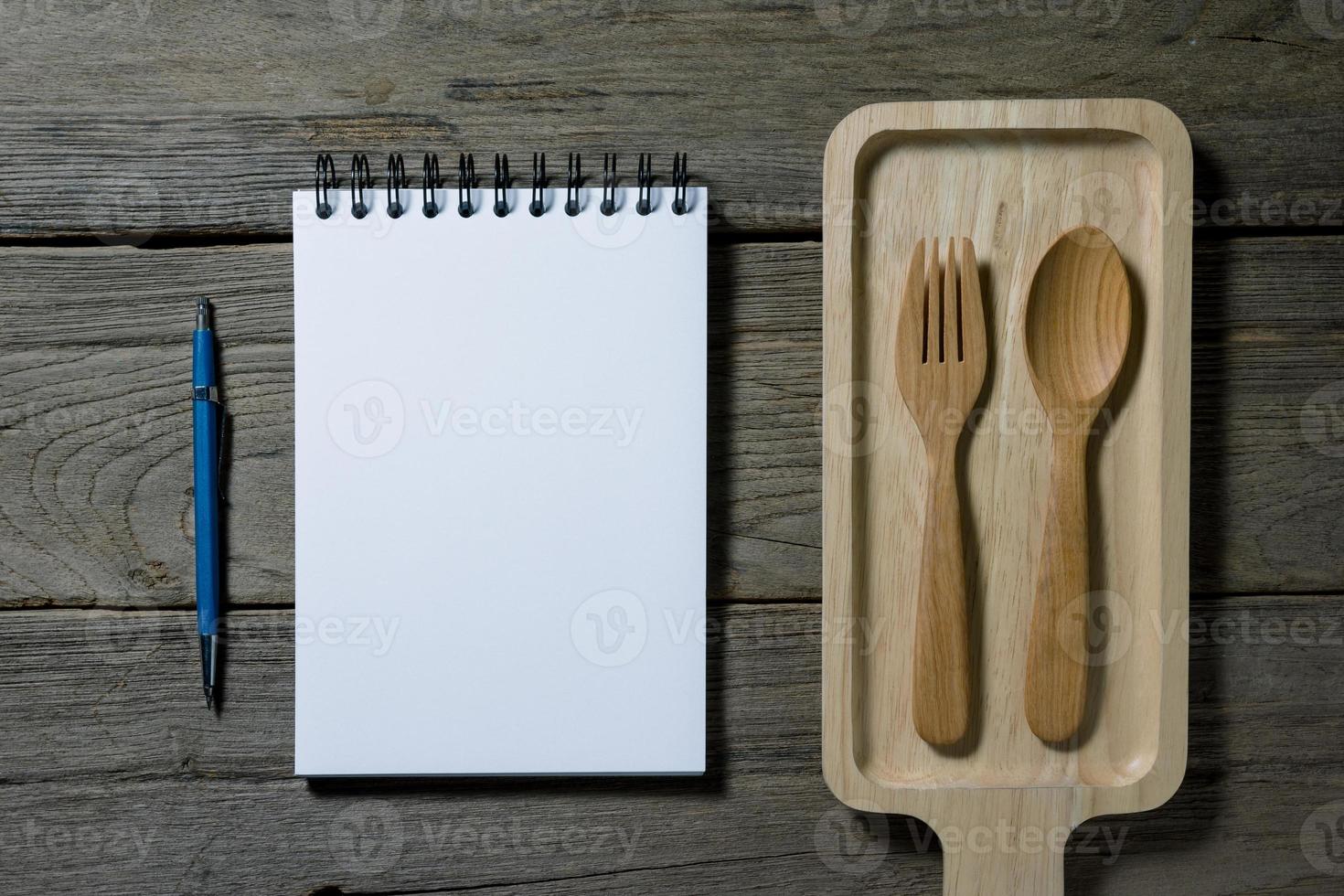 open note book with wooden tray on desk photo