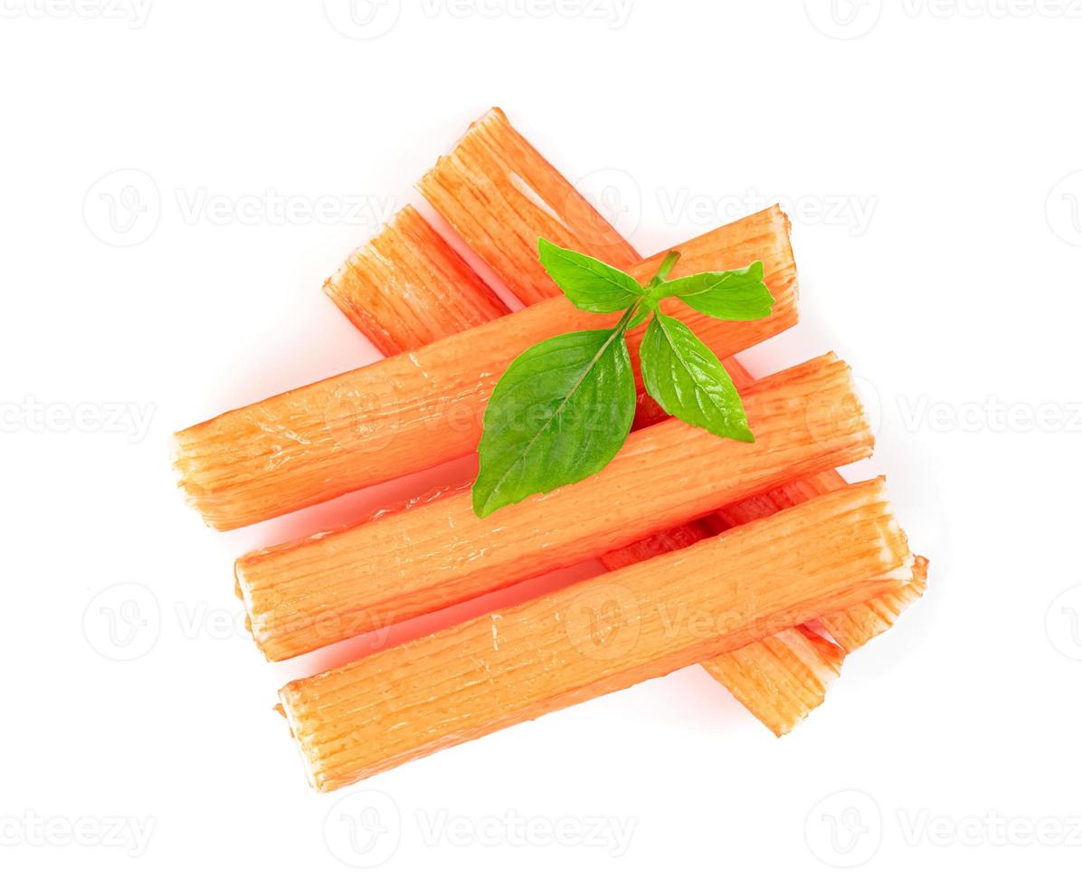 closeup crab sticks with basil leaves isolated on white background photo