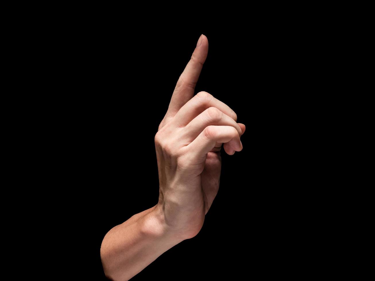 Male hand on a black background. photo