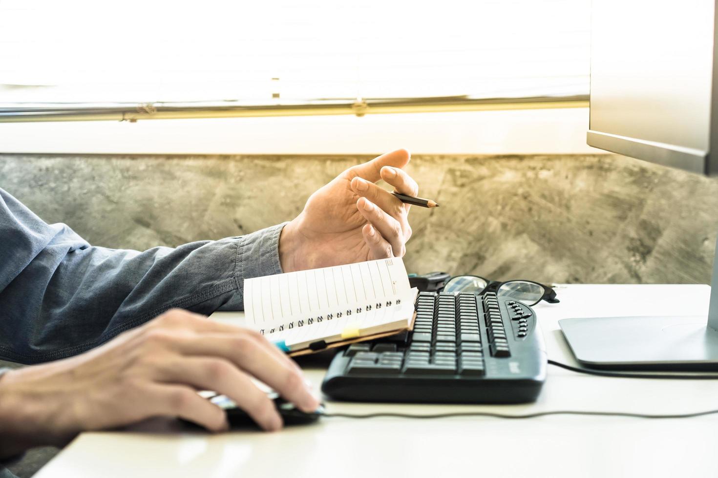 Close up of Male hands writing some data in notebook on the desk photo