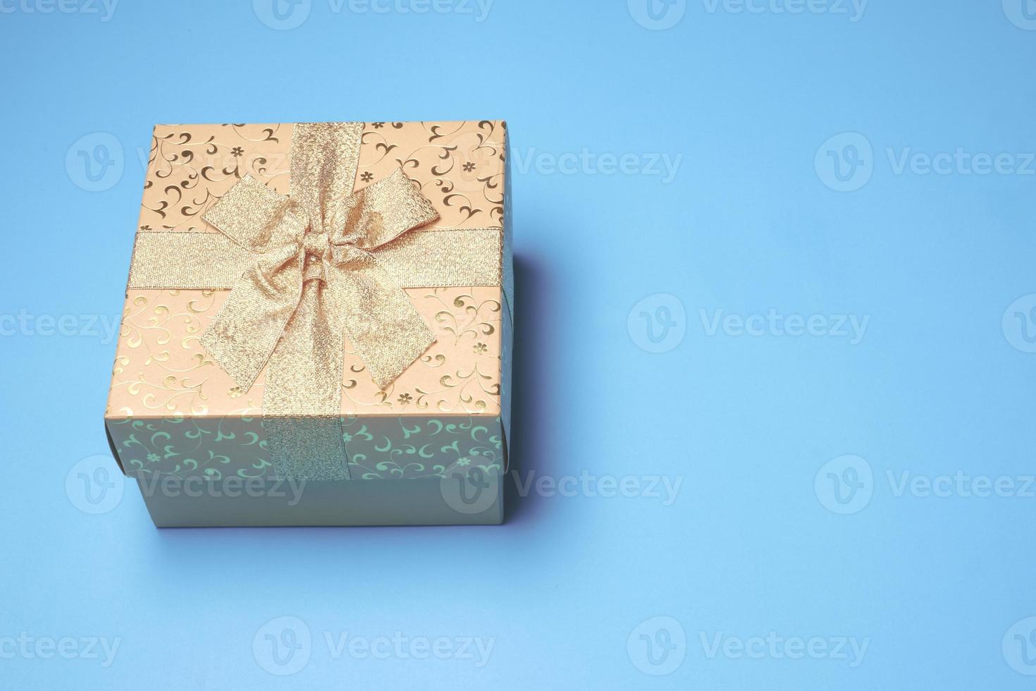 Top view of gift box on blue background. Free space for text photo