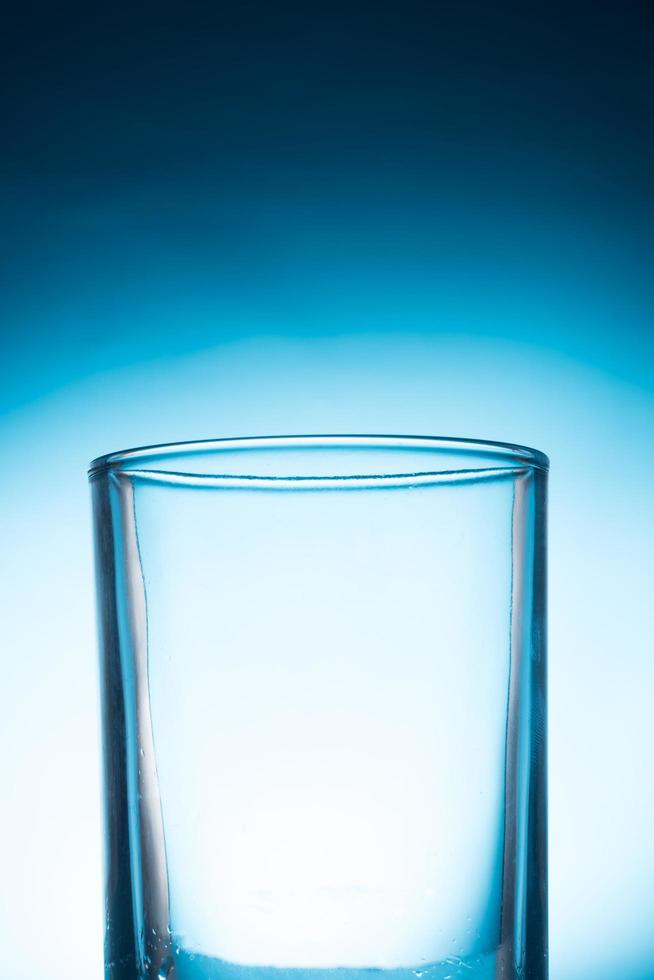 Empty glass on a blue background. photo