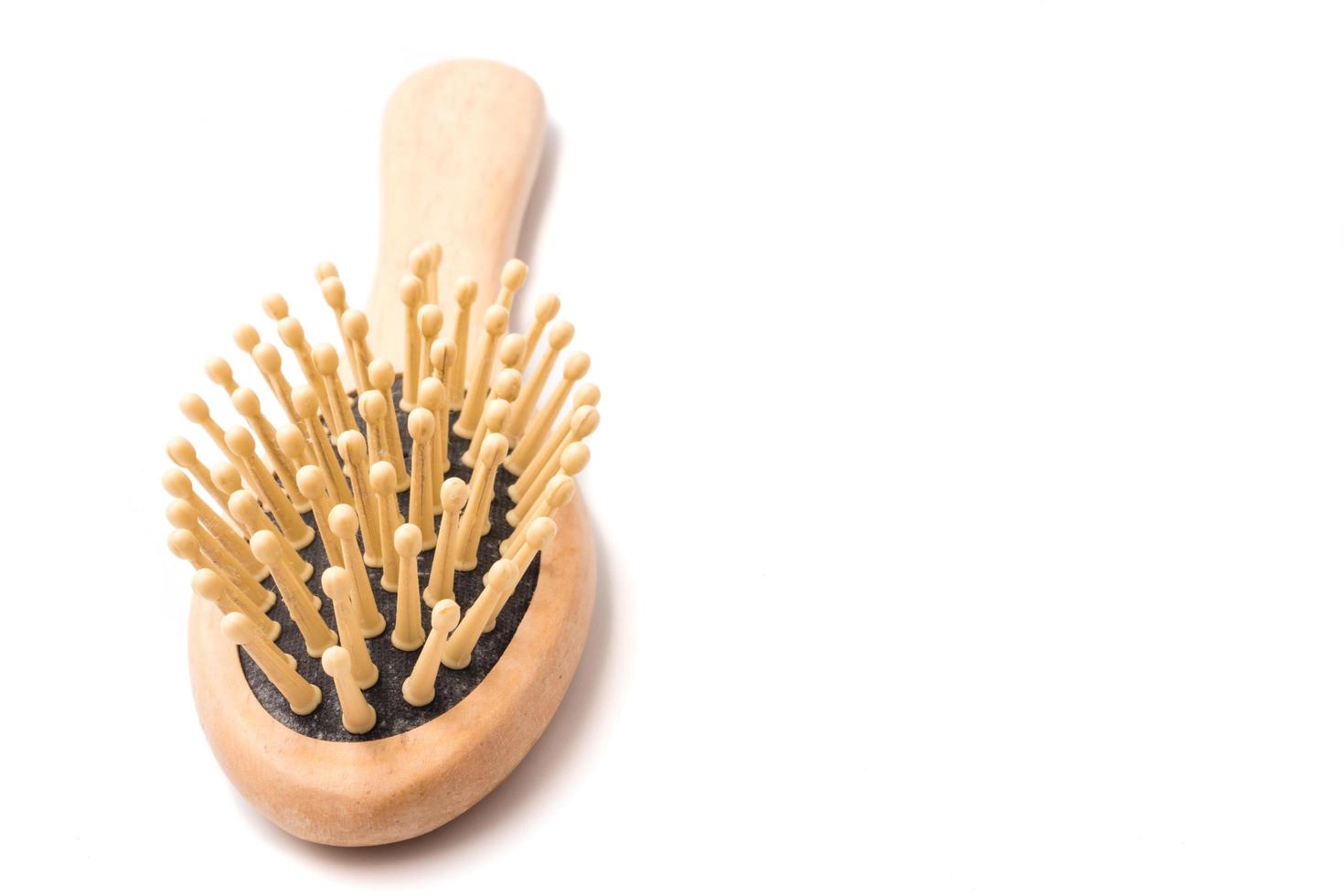 Wooden comb on a white background. Free space for text photo
