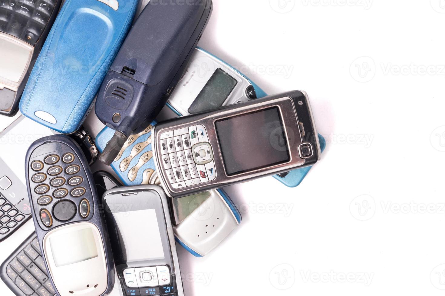 old and obsolete cellphone on a white background. Free space for text photo