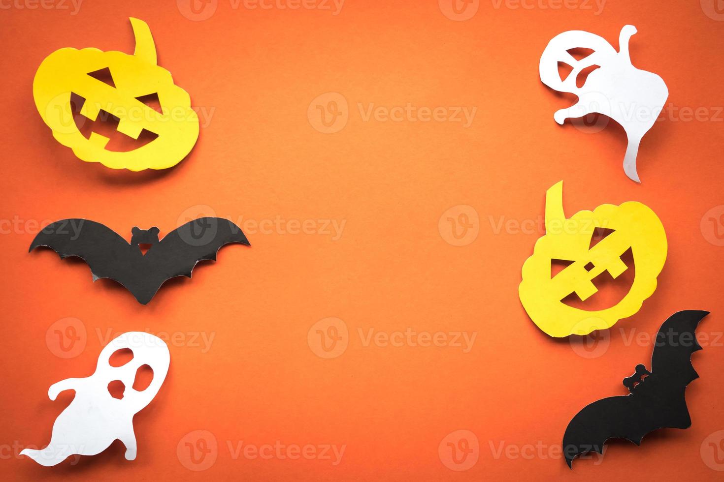 Halloween holiday background with pumpkins, ghosts and bats cut paper on orange background. Free space for text. photo