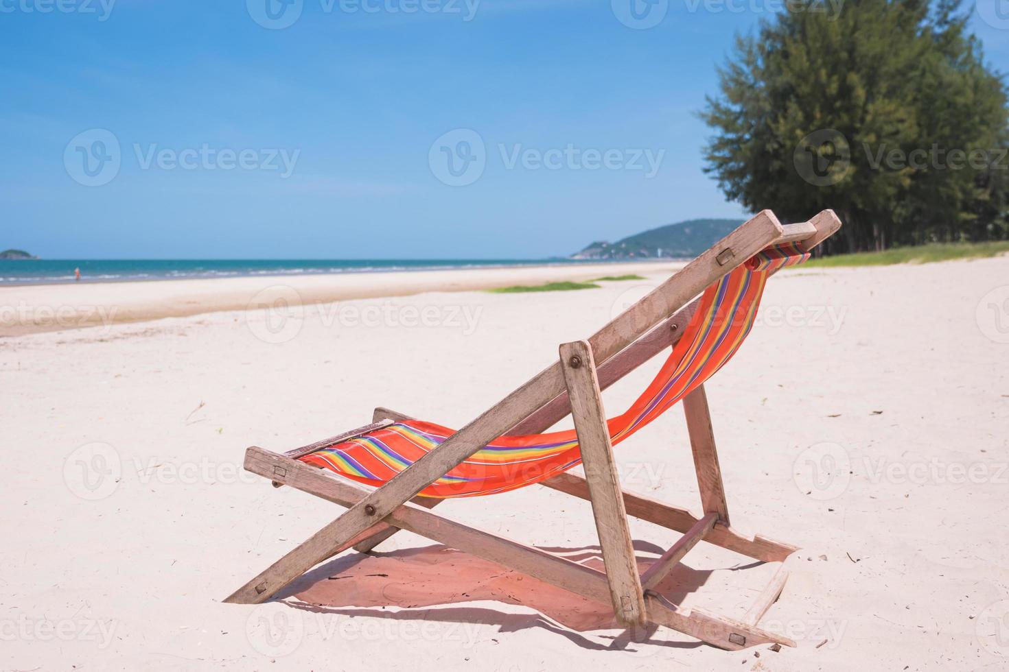 Red canvas chair on the beach. photo