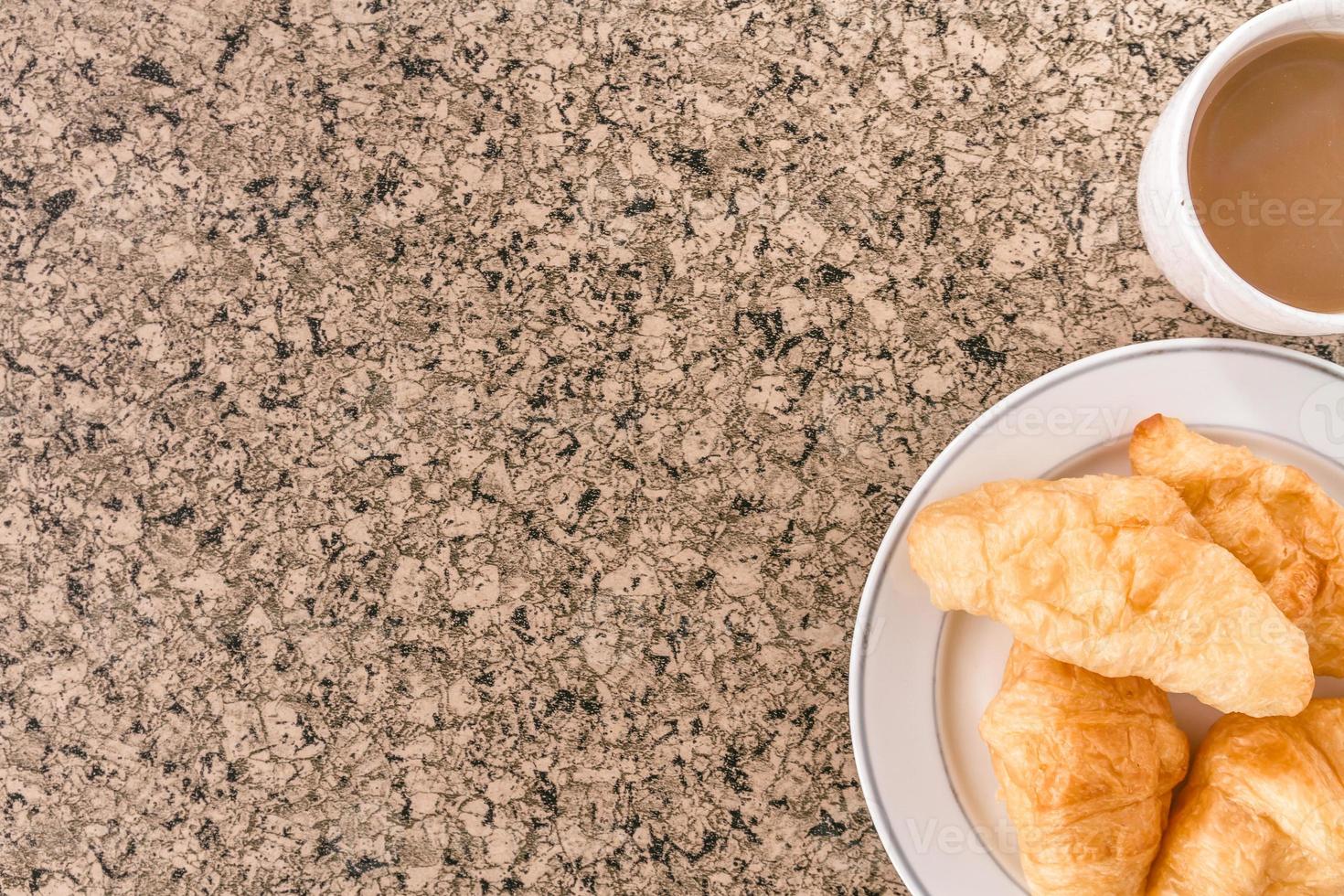 Breakfast with cup of coffee, croissant on the table. Free space for text photo