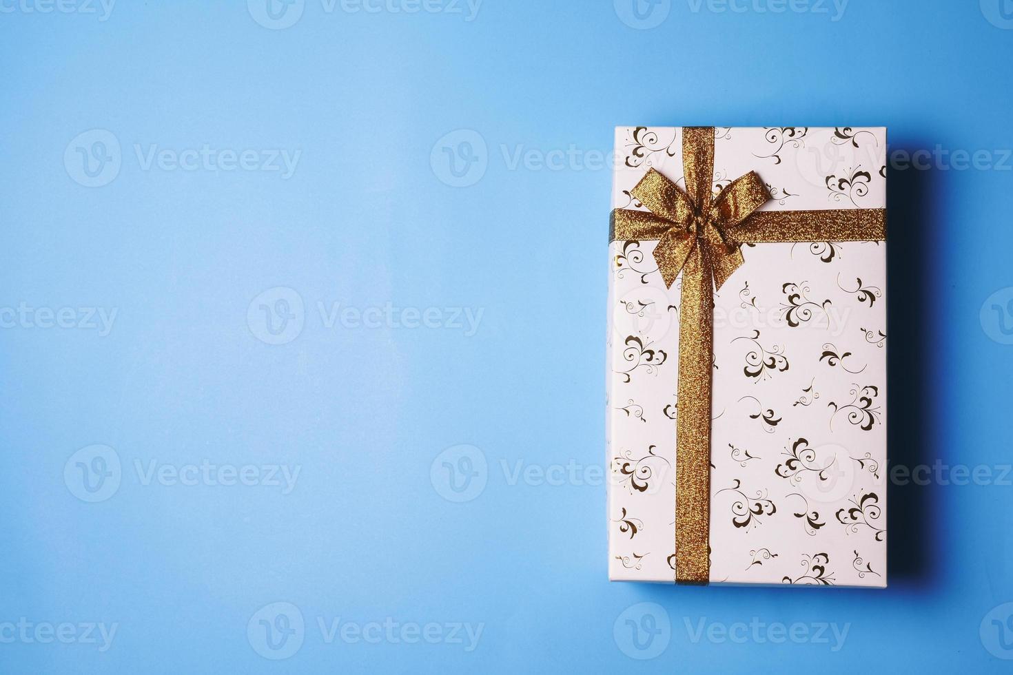 Top view of gift box on blue background. Free space for text photo