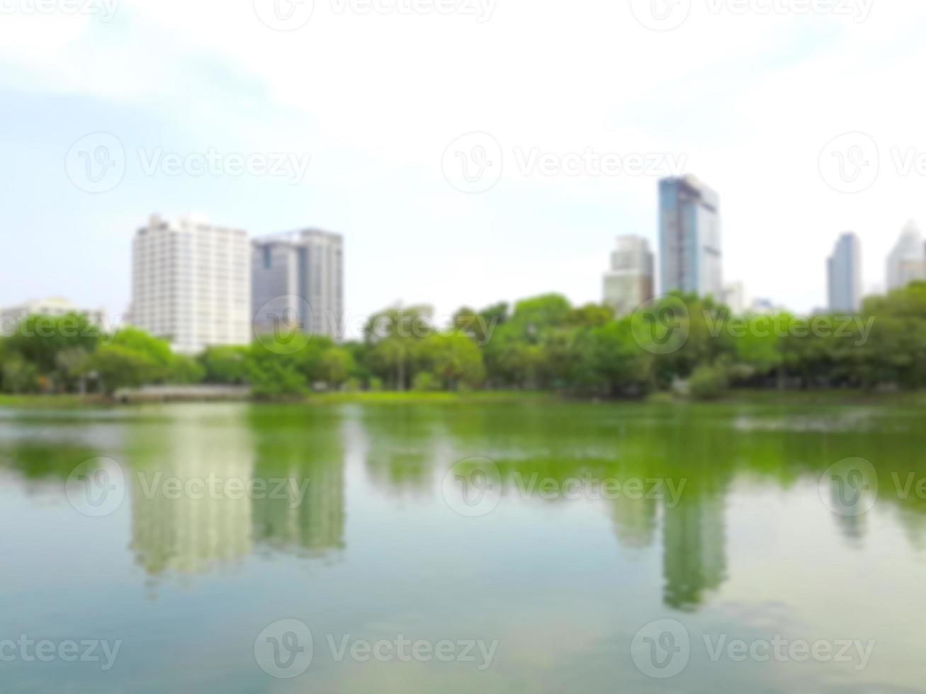 Building and pond in public park blur background of Illustration,Abstract Blurred photo