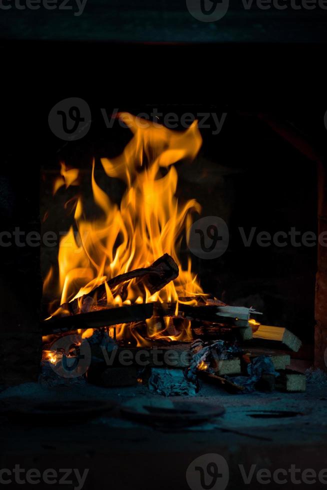 Crest of flame on burning wood in fireplace. Burning firewood in a Russian stove. photo