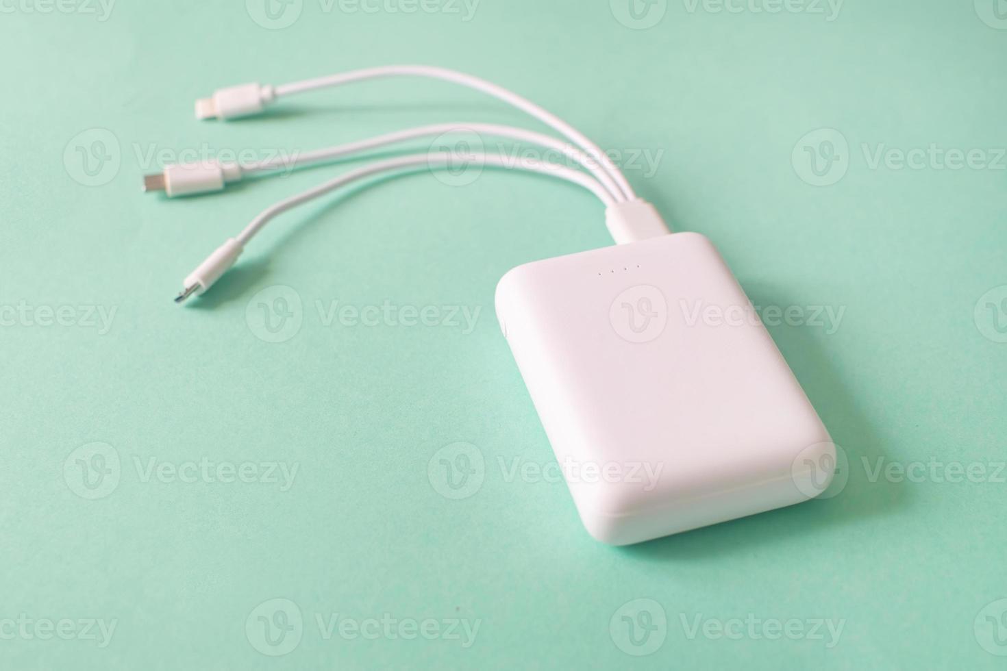 Powerbank on green background. Powerbank with different connectors. photo