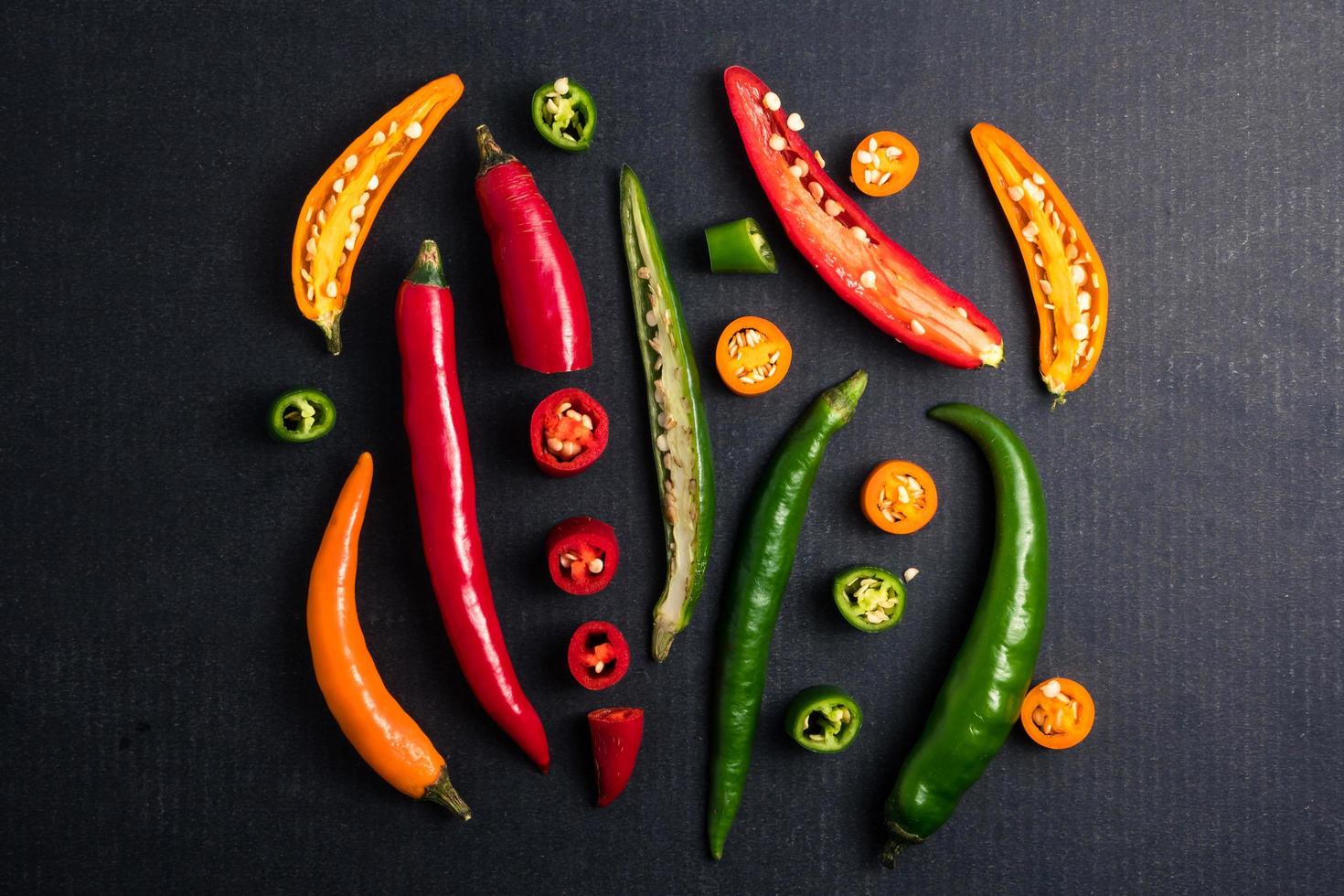 Colorful mix of chili pappers on black background. photo