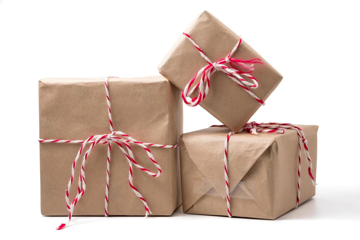 Gift packages wrapped in brown paper on white background. 10723708