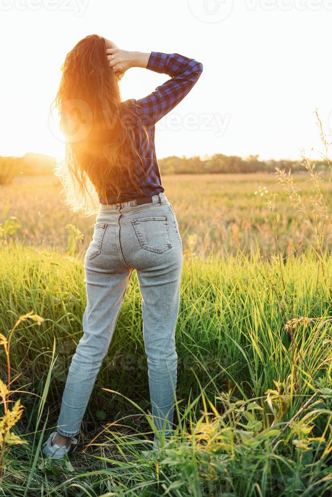 Portrait of a beautiful young woman on meadow photo