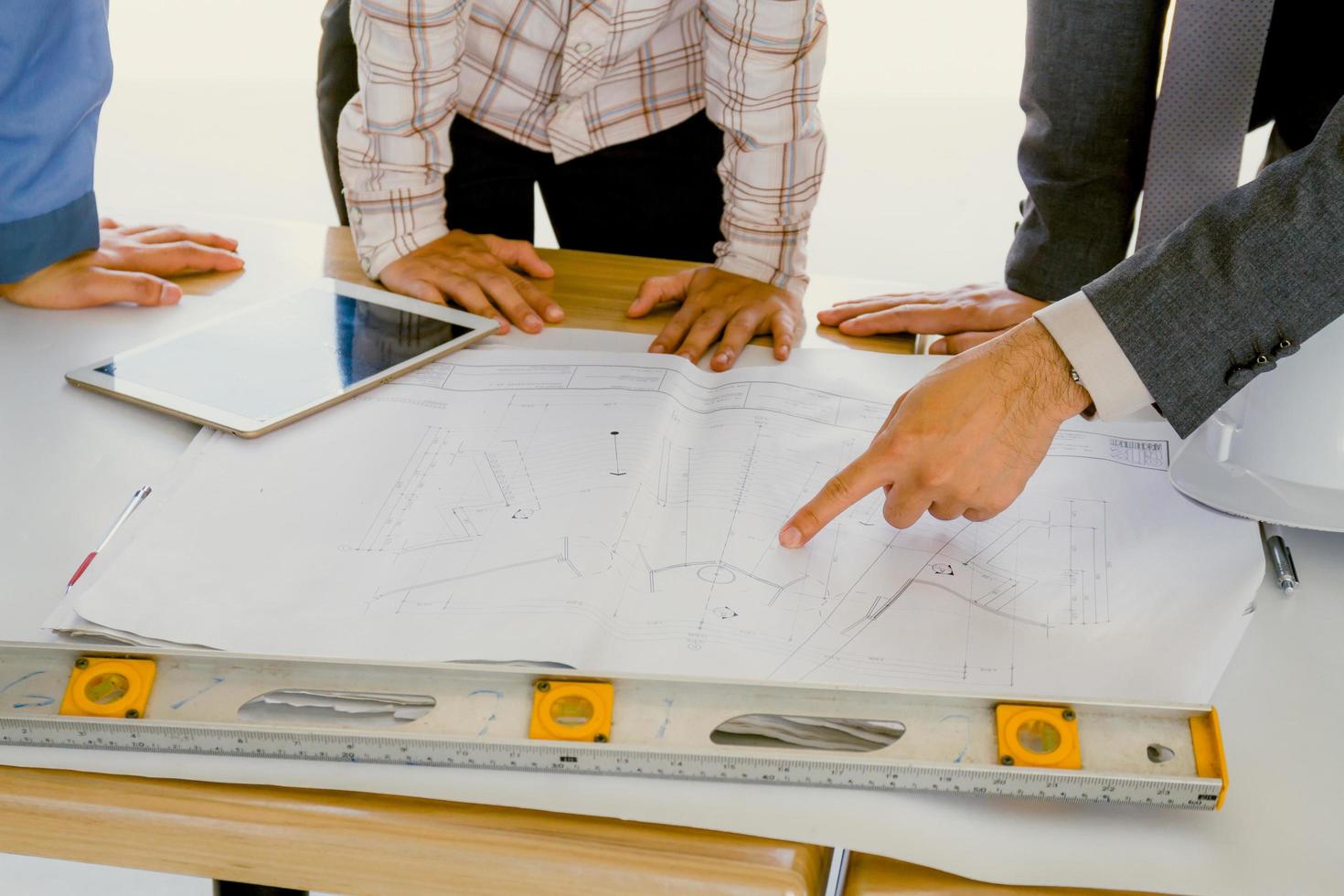 Team of engineers discussing architecture plan sketch at the construction site. photo