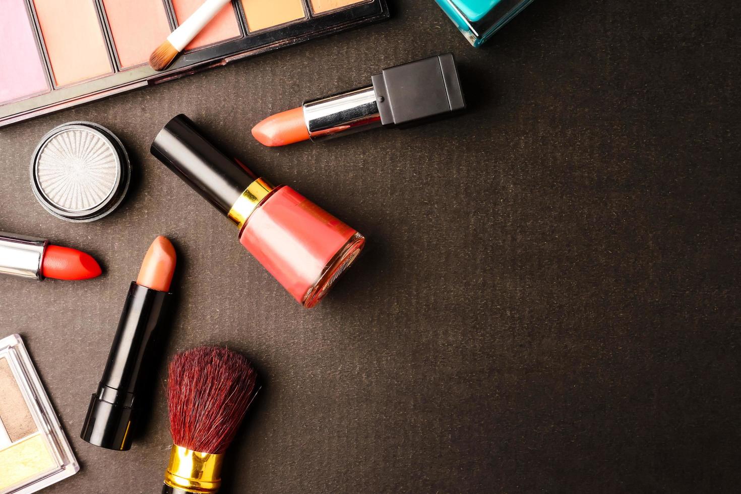 Top view of cosmetics set for makeup on a black background. Free space for text. photo