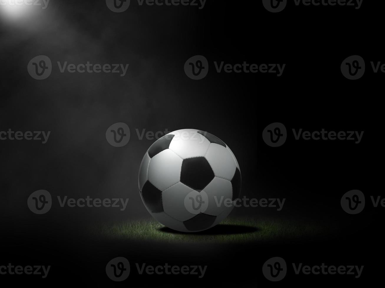 Soccer ball on lawn with black background photo