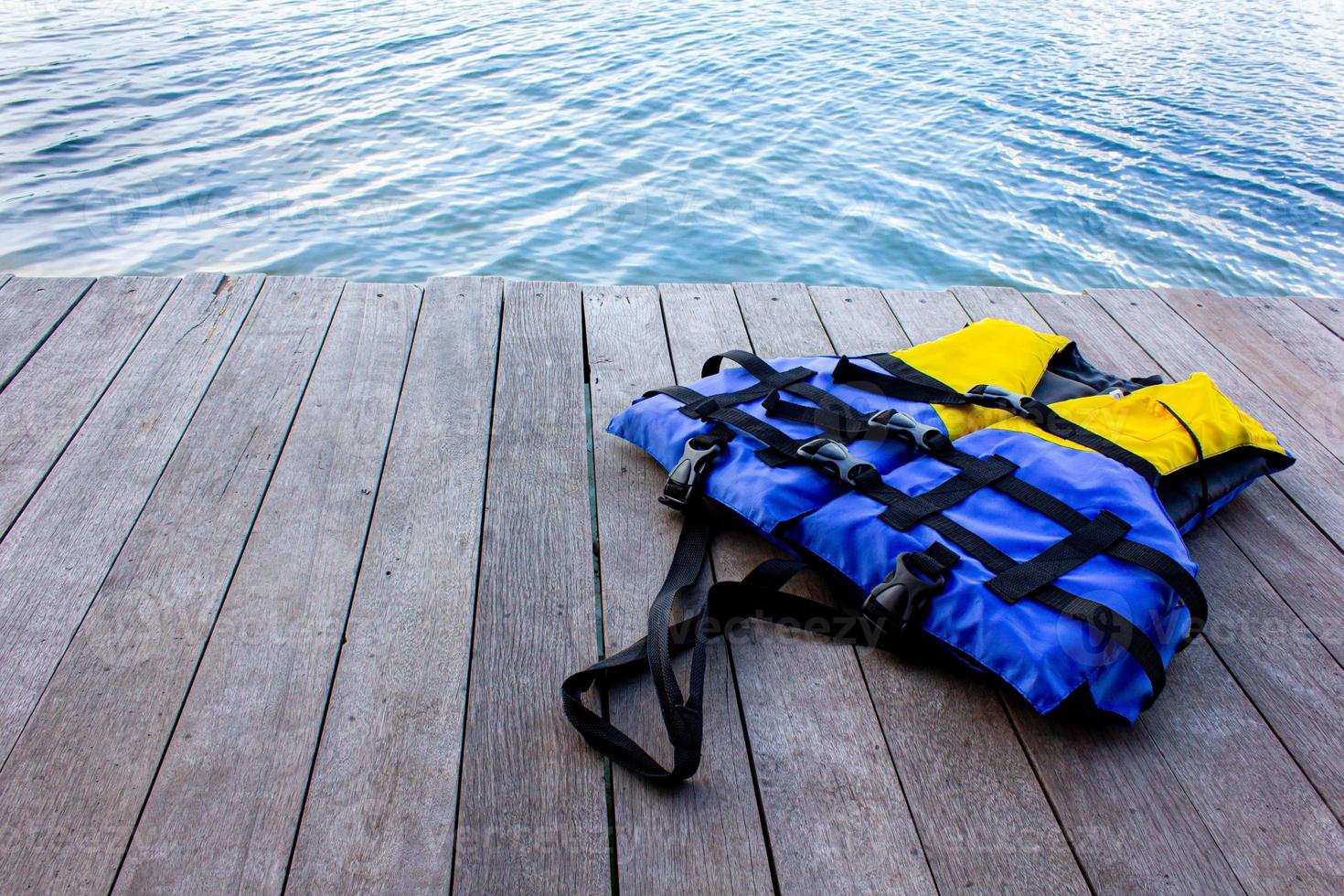 life jacket on wooden floor for product placementwith natural pattern texture. photo