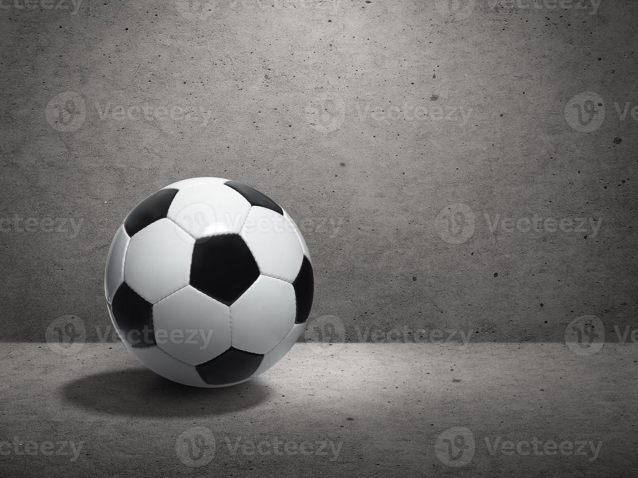 Soccer ball on cement wall background photo