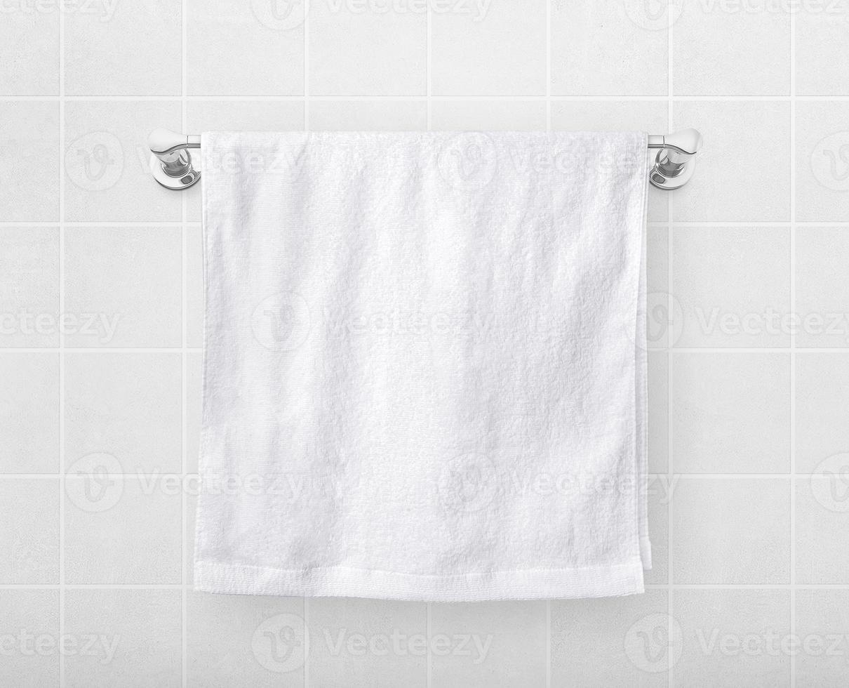 White towels hang on a hanger rod. photo