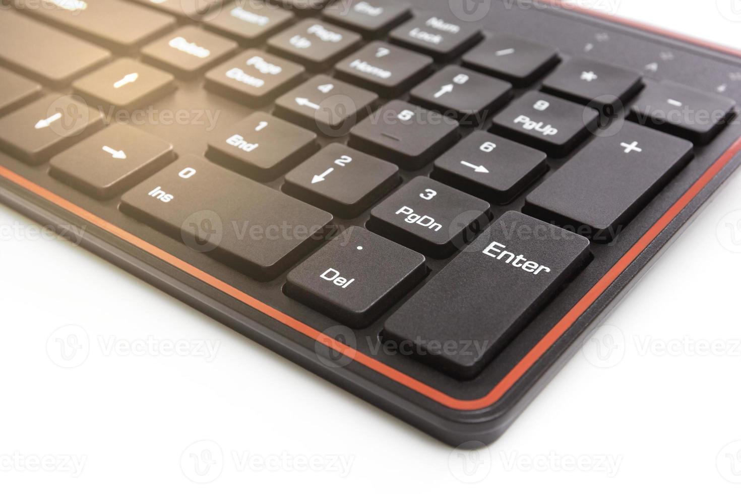 Close up of black keyboard on white background,light effect photo