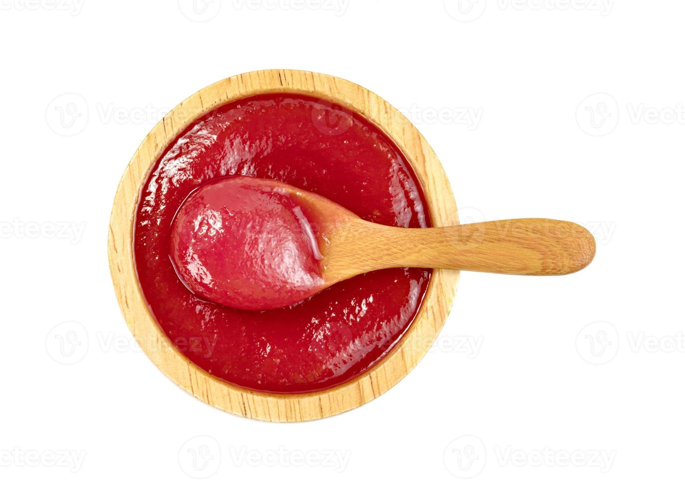 tomato sauce in wooden bowl and spoon isolated on white background photo