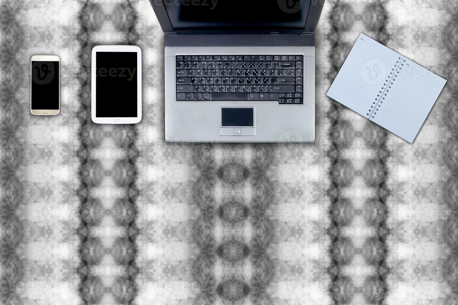 laptop and table workspace office on abstract pattern photo