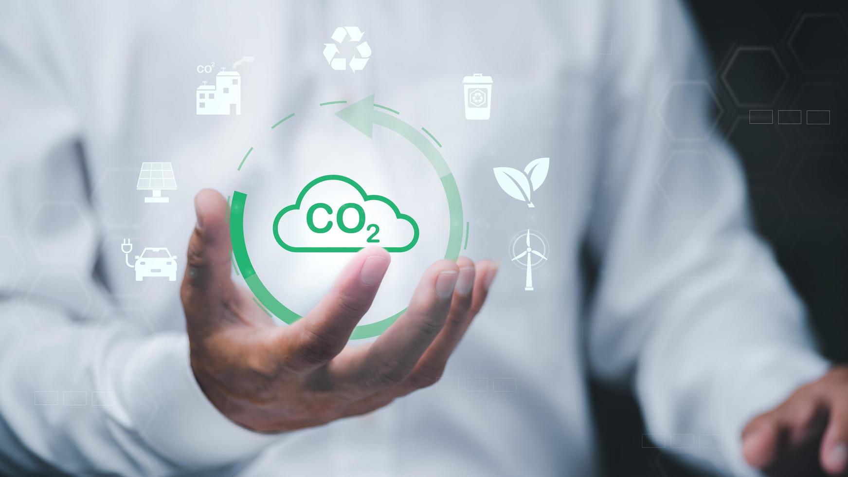 Industrial emissions pollute the environment and ecosystems. including climate change Carbon Renewable Energy Agreement reduce greenhouse gas emissions , businessman holding icon in hand photo