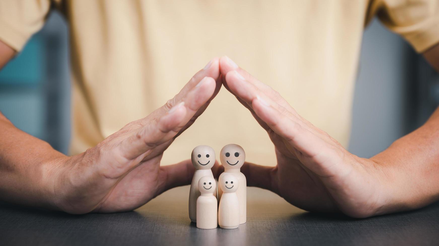 Father put his hand next to a wooden block to show protection for the family. and support and help advice The concept of family relationships to be connected to safety loving kindness photo