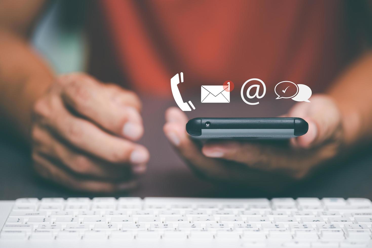 man holding a smartphone showing a concept Customer Support Hotline Contact Us Connectivity ,Cyberspace through the online system in everyday life. that plays a role in finance, shopping and marketing photo