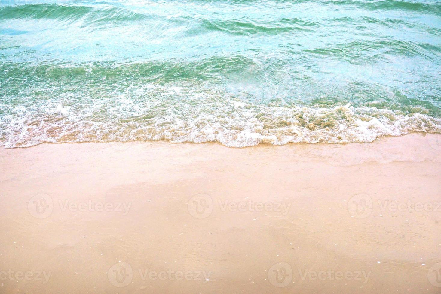 The light wave and beautiful green sea with space for texts on the beach background.. photo