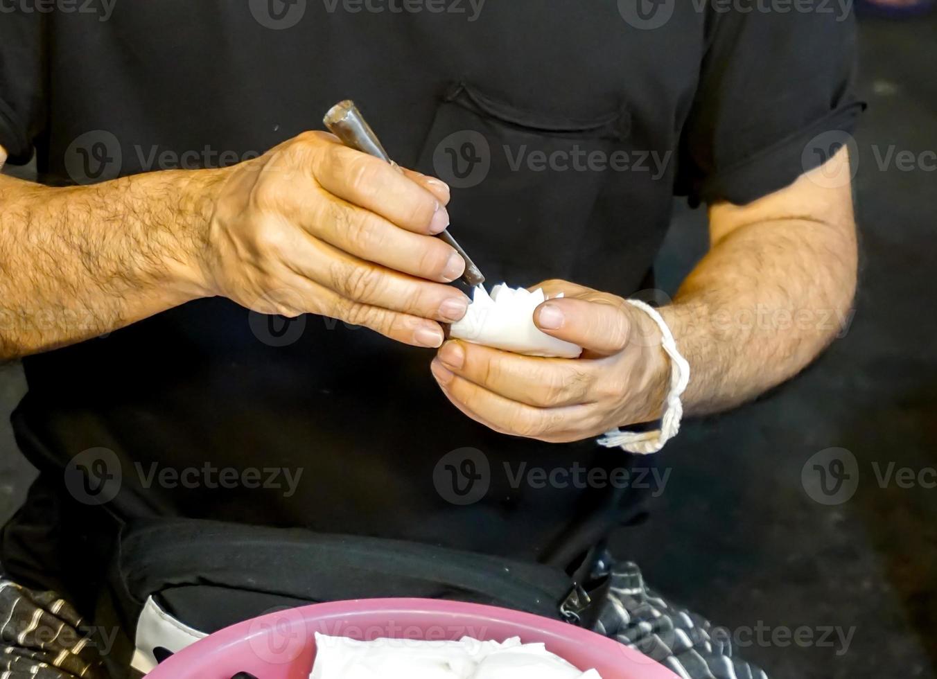 Closeup hands of Thailander carving aroma flower soaps at Chiang Mai.Thailand. photo