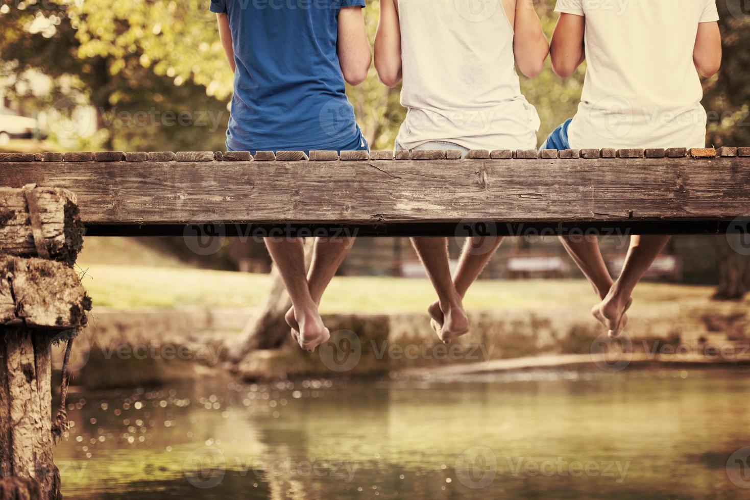 people sitting at wooden bridge photo