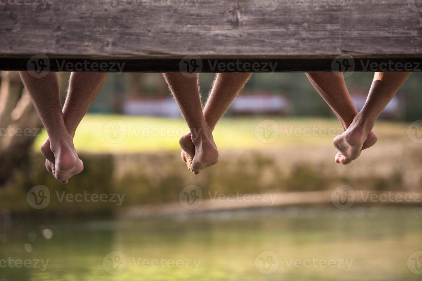 people sitting at wooden bridge photo