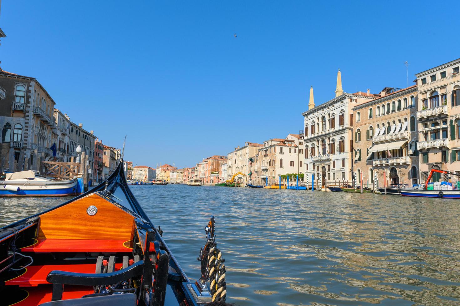 Gondola sailing in the canals of Venice photo