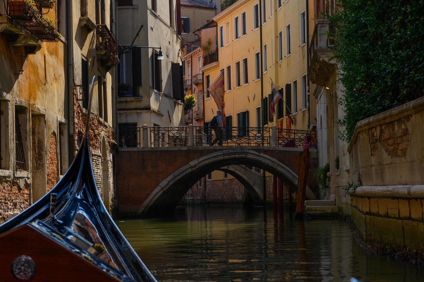 Gondola sailing in the canals of Venice photo