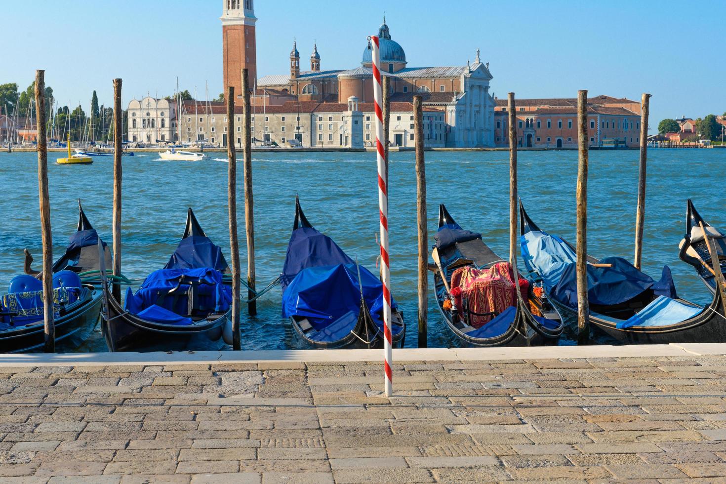 Gondolas docked in the harbour in Venice photo