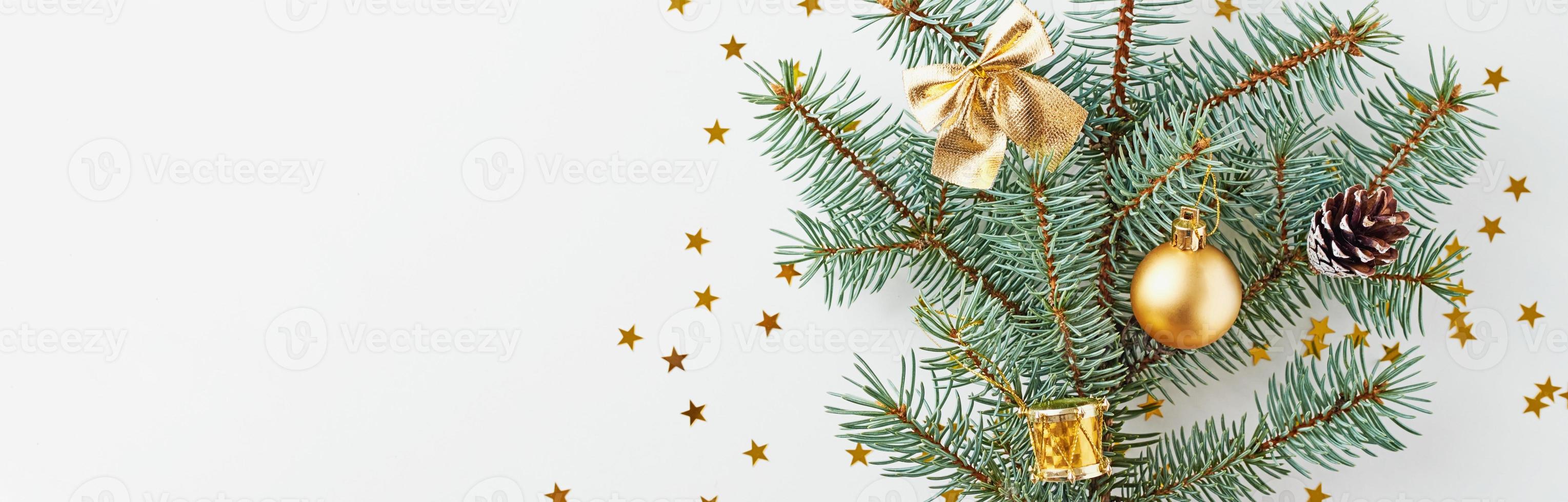 Christmas tree decorated with golden balls and christmas toys on white background, long banner photo