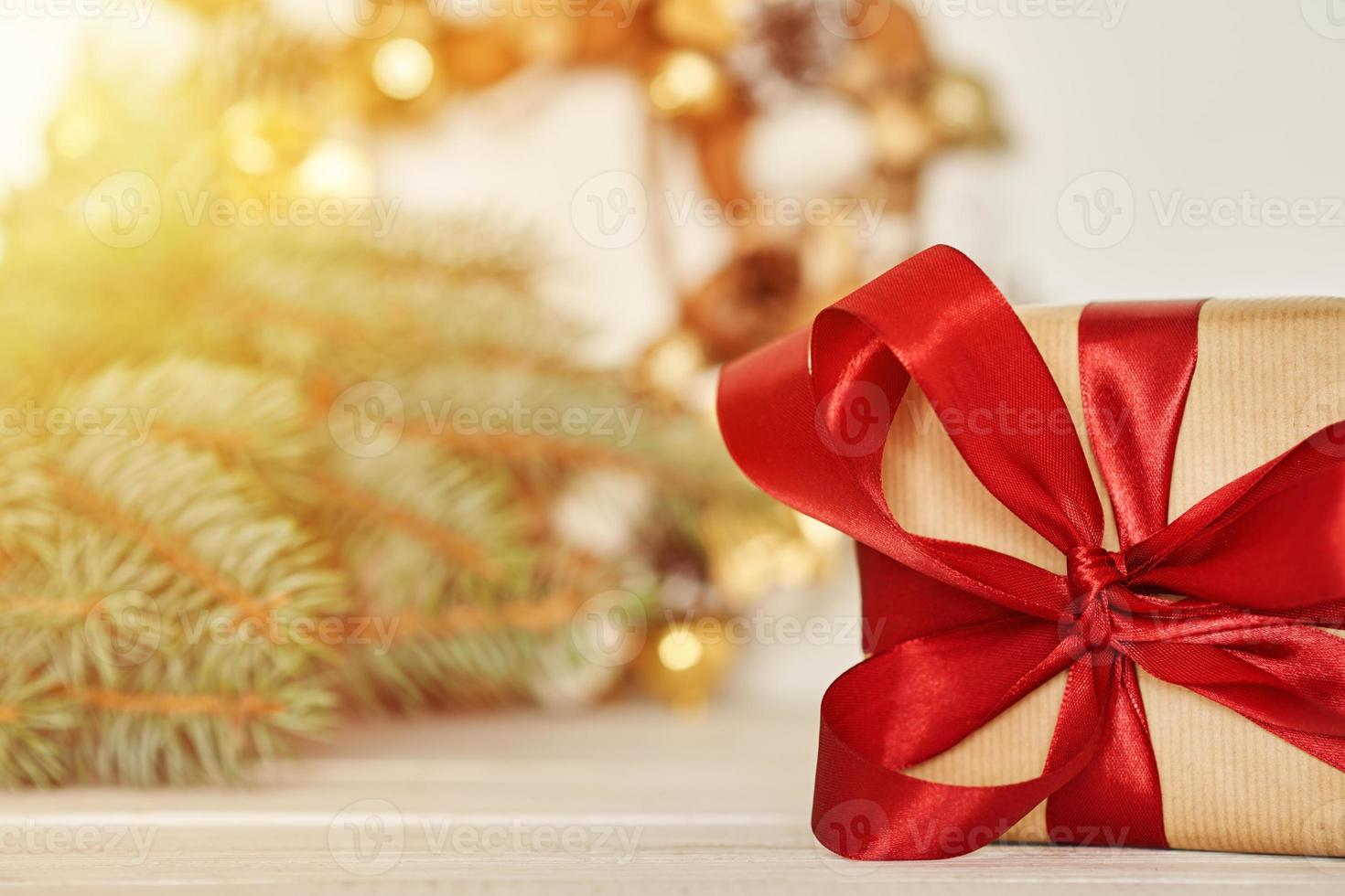 Christmas gift box with ribbon and christmas decorations photo