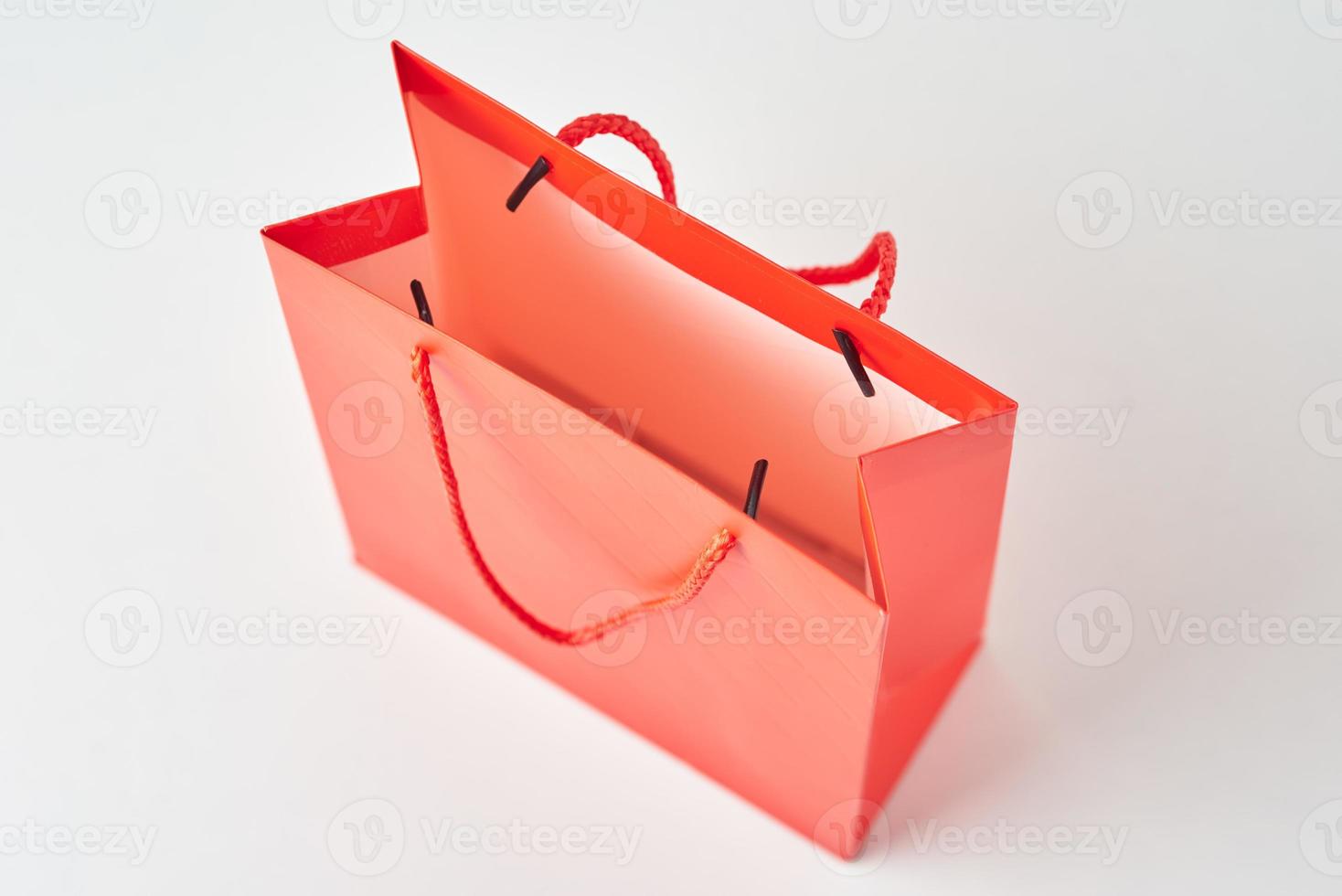 Top view inside open red paper shopping bag on white background. photo
