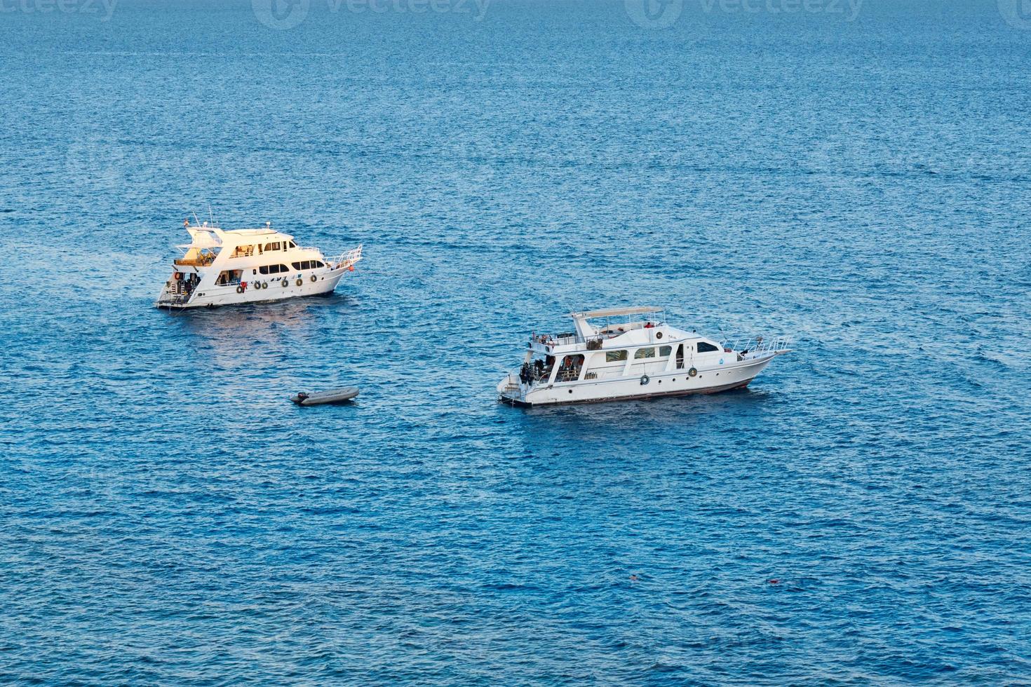 Two white ship in blue water of sea or ocean photo
