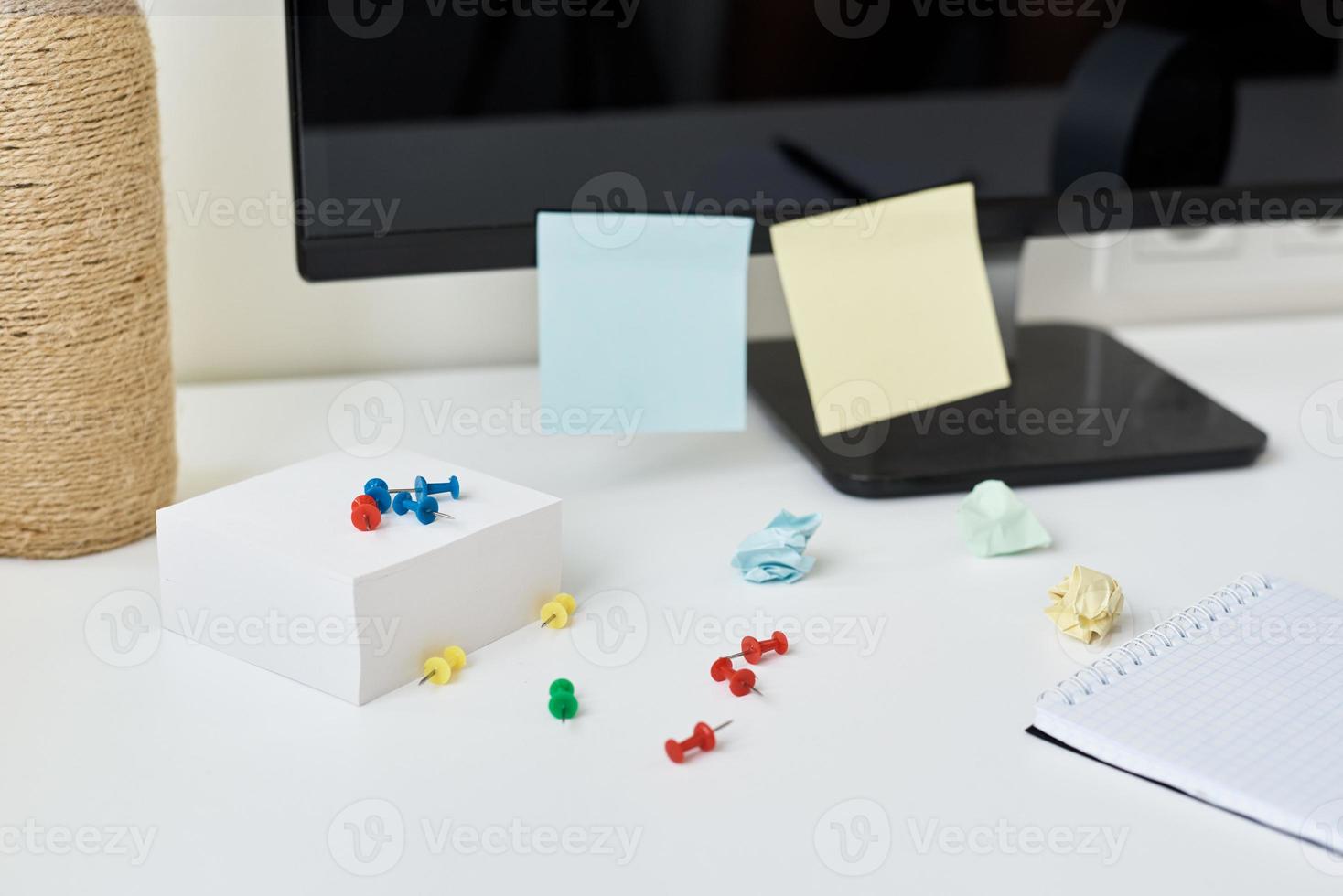 Workplace with office supplies and sticky notes on a table photo