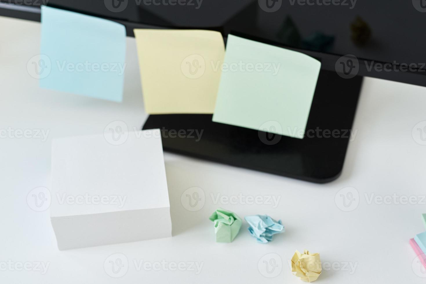 Workplace with office supplies and sticky notes on a table photo
