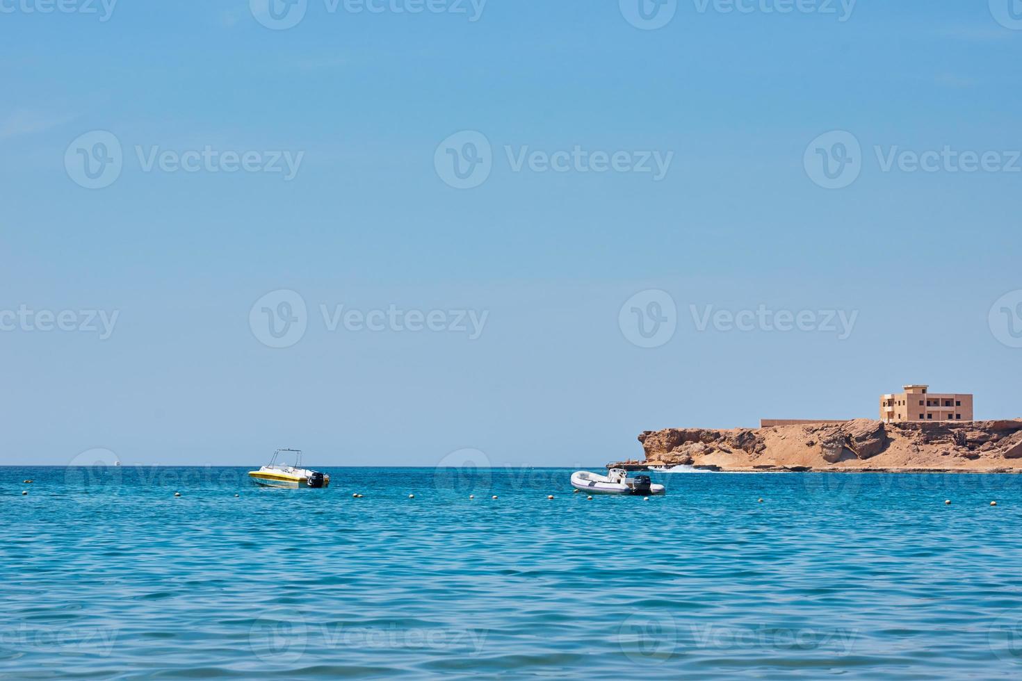 Beautiful view of sea cost against blue sky photo