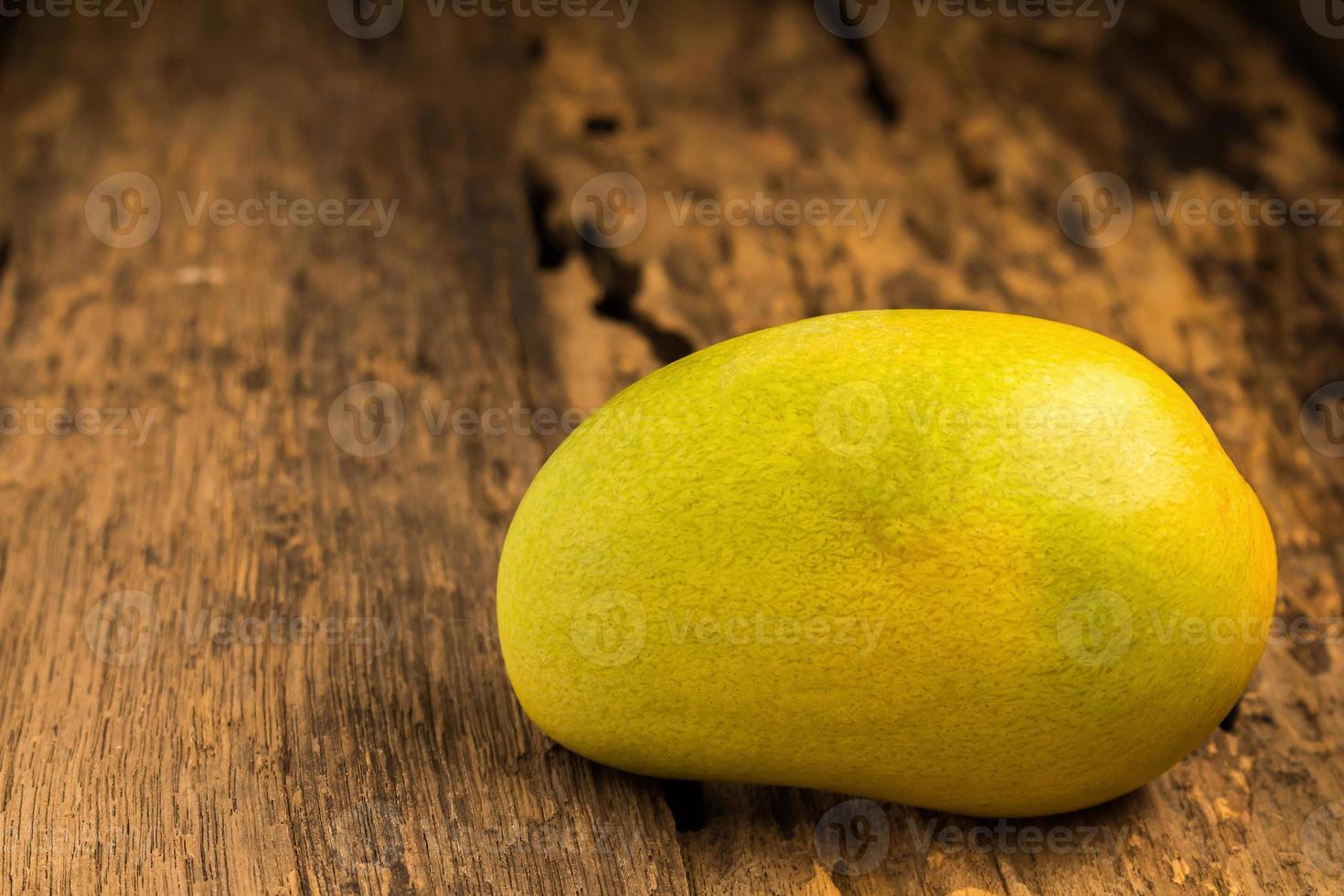 mango on a dark wood background 10729386 Stock Photo at Vecteezy